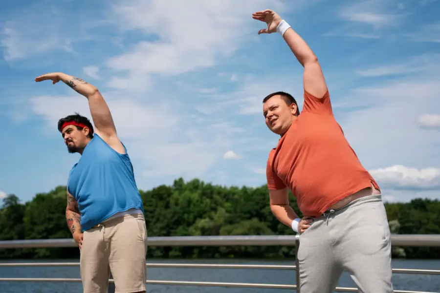 Side view men exercising together outdoors